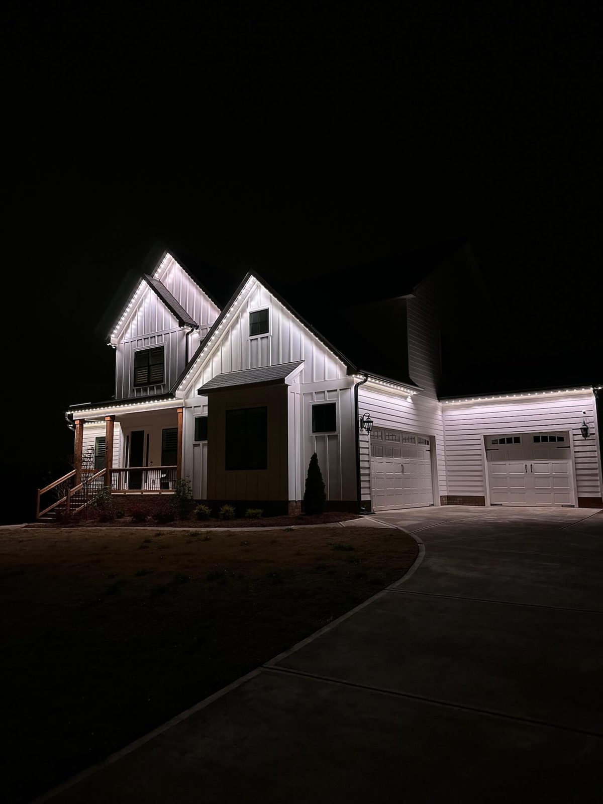 Home with crisp white permanent lighting under the soffits